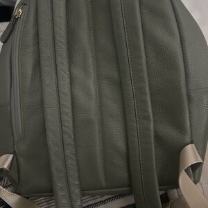 A sage/olive green Michael Kors backpack. Good condition.